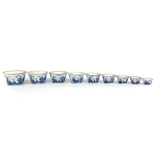 386 - Graduated set of nine Chinese blue and white porcelain bowls, each hand painted with a continuous ba... 