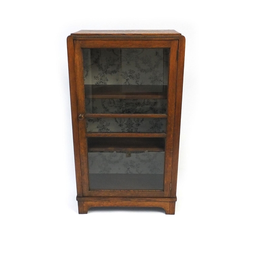 46 - Glazed oak bookcase fitted with two shelves, 109cm high x 60cm wide x 30cm deep