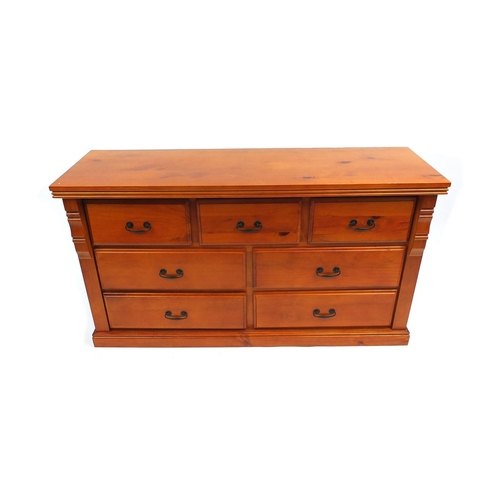 21 - Pine seven drawer chest, 77cm high x 140cm wide x 45cm deep