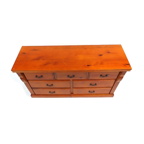 21 - Pine seven drawer chest, 77cm high x 140cm wide x 45cm deep