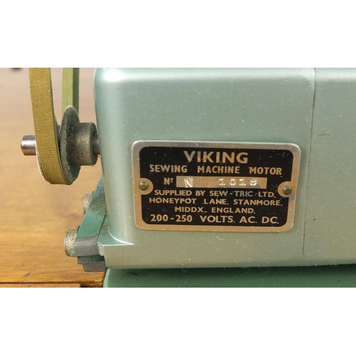 17 - Walnut sewing machine table raised on cabriole legs housing a Viking sewing machine, 85cm high