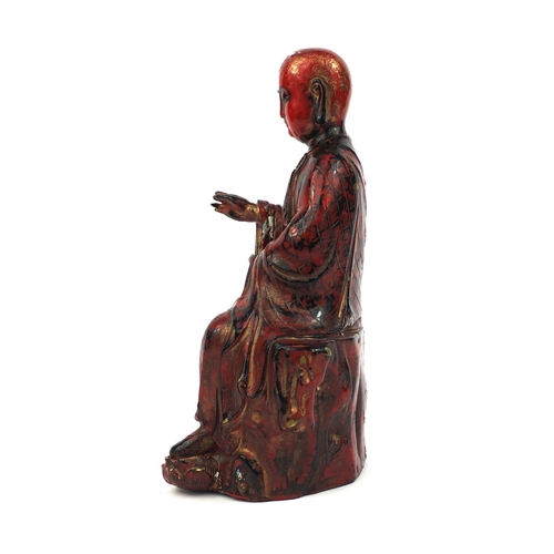 466 - Chinese seated metal Buddha painted in iron red, 29cm high