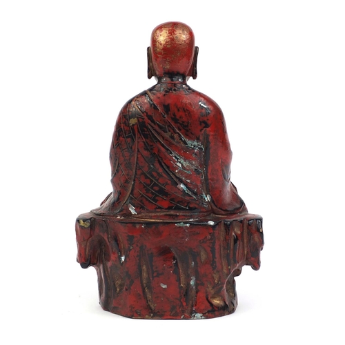 466 - Chinese seated metal Buddha painted in iron red, 29cm high