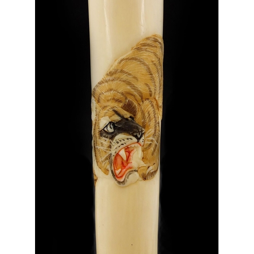 462 - Japanese ivory parasol handle of cylindrical tapering form, carved with two tigers, with attached pa... 