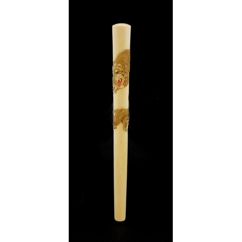 463 - Japanese ivory parasol handle of oval tapering form, carved with two tigers, with attached paper lab... 