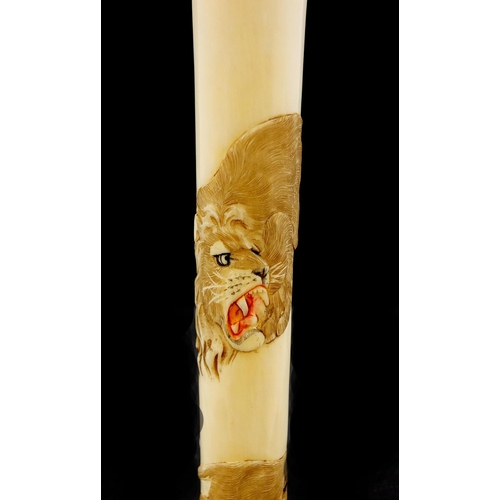 463 - Japanese ivory parasol handle of oval tapering form, carved with two tigers, with attached paper lab... 