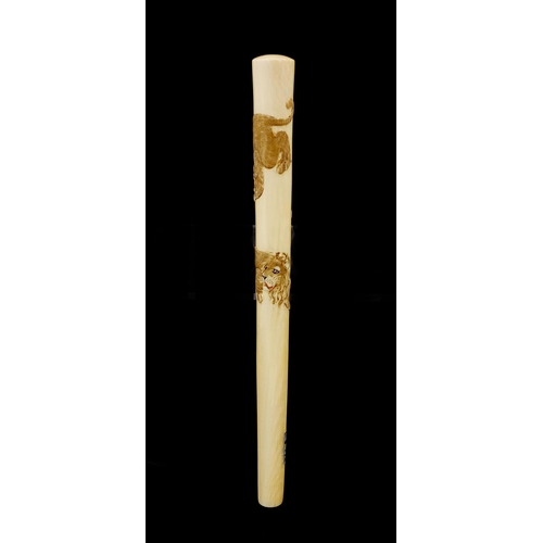 463 - Japanese ivory parasol handle of oval tapering form, carved with two tigers, with attached paper lab... 