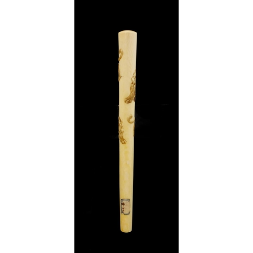 463 - Japanese ivory parasol handle of oval tapering form, carved with two tigers, with attached paper lab... 