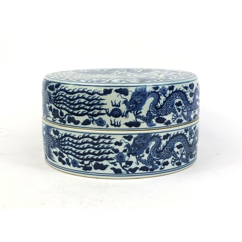 401 - Chinese circular blue and white porcelain box and cover, profusely hand painted with dragons and pho... 