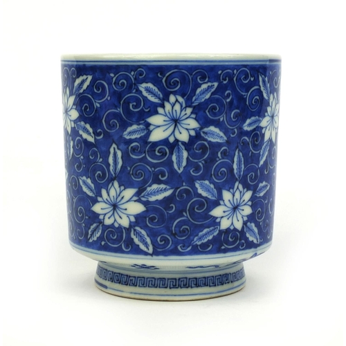 392 - Chinese blue and white porcelain brush pot, hand painted with flowers amongst foliate scrolls, six f... 