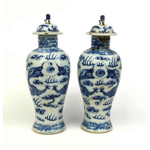 395 - Pair of Chinese blue and white porcelain baluster vases and covers, each hand painted with dragons c... 