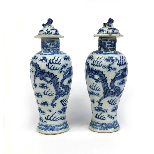 395 - Pair of Chinese blue and white porcelain baluster vases and covers, each hand painted with dragons c... 