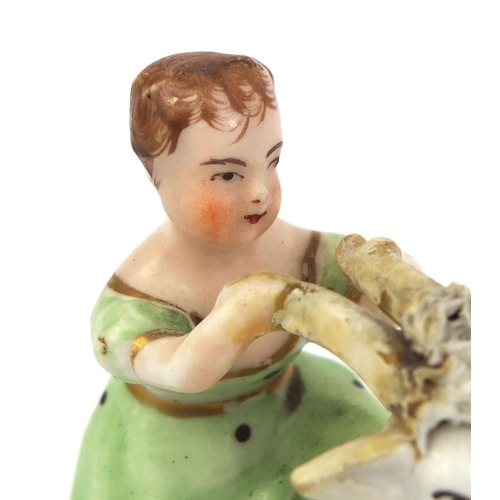 540 - 19th Century Staffordshire model of a girl on a goat, Pearlware figure of a shepherd and a porcelain... 