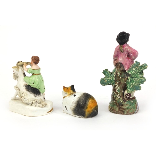 540 - 19th Century Staffordshire model of a girl on a goat, Pearlware figure of a shepherd and a porcelain... 