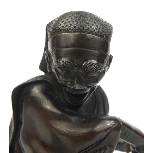 464 - Japanese bronze study of man playing with a monkey, 14.5cm high