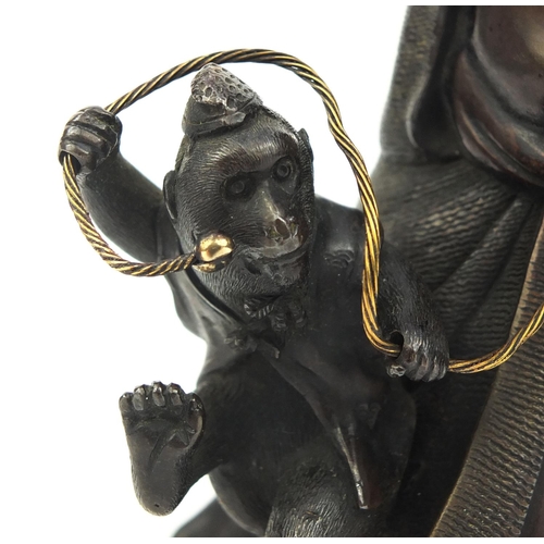 464 - Japanese bronze study of man playing with a monkey, 14.5cm high