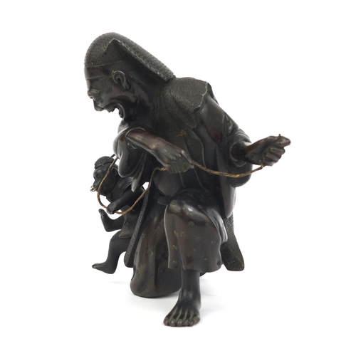 464 - Japanese bronze study of man playing with a monkey, 14.5cm high