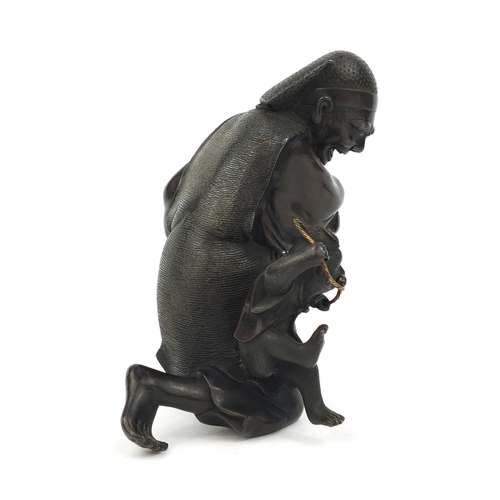 464 - Japanese bronze study of man playing with a monkey, 14.5cm high