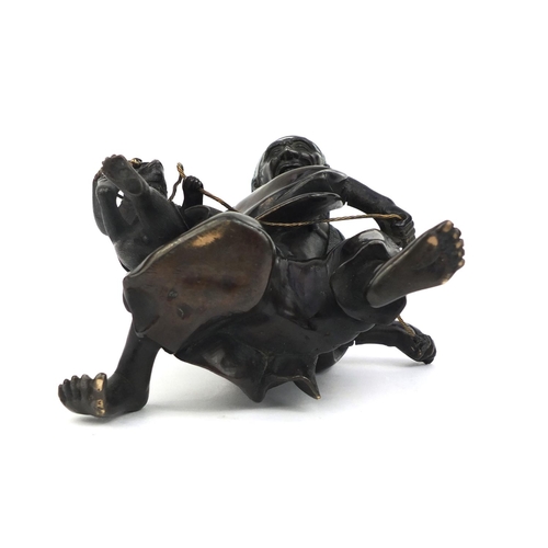 464 - Japanese bronze study of man playing with a monkey, 14.5cm high