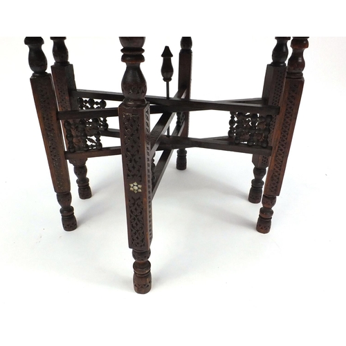 54 - Folding carved wooden table with decorative circular brass top decorated with elephants