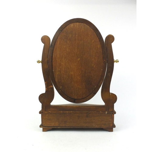 7 - Mahogany oval swing mirror with serpentine fronted jewellery drawers, 58cm high