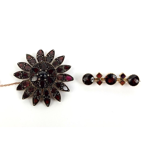 815 - Two gilt metal garnet brooches, the larger 4cm in diameter, approximate weight 11.2g