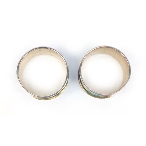 710 - Cased pair of silver guilloche enamelled napkin rings, each stamped 925, 4.5cm in diameter, approxim... 