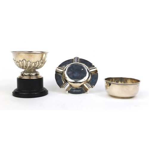 714 - Silver items comprising pedestal bowl with demi fluted decoration, a Captains cup golf ashtray and a... 