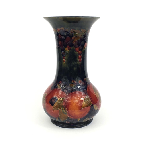 619 - Large William Moorcroft pomegranate pattern pottery vase, with hand painted and tube lined decoratio... 