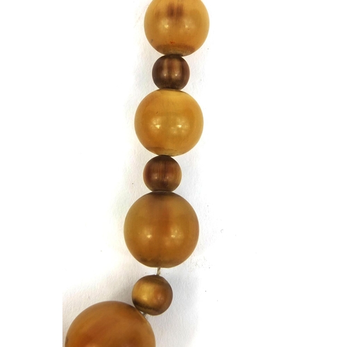 434 - Horn beaded necklace, possibly rhino horn, the largest bead 2cm in diameter, approximately 61cm long... 