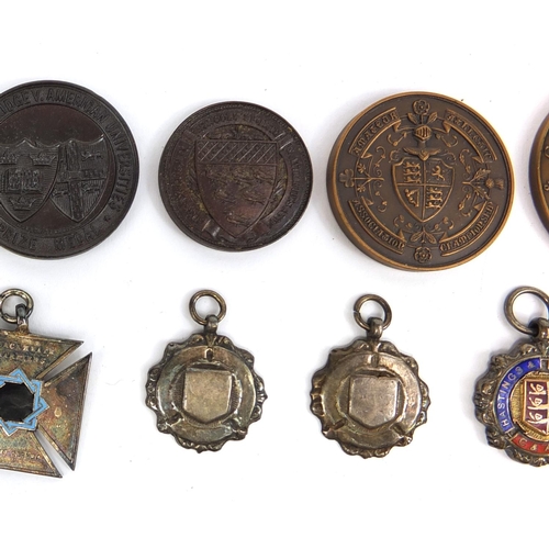 128 - Group of athletic competitors and winners jewels, badges and spoons, including silver examples, rela... 