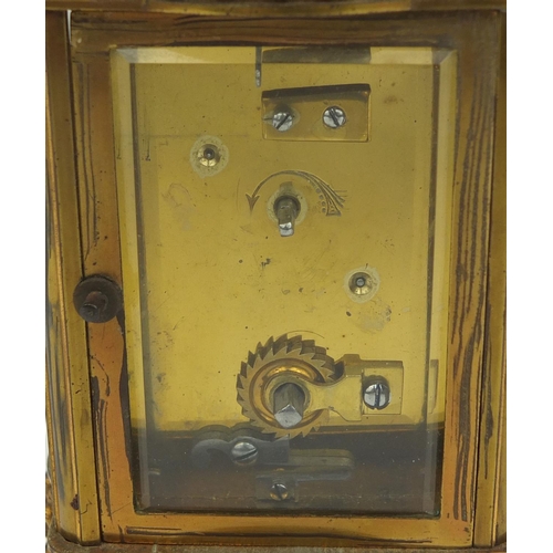 746 - Brass cased carriage clock with bevelled glass, decorated with foliate scrolls, the enamelled chapte... 