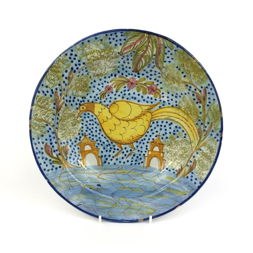 567 - Continental majolica shallow dish hand painted with a stylised bird in a landscape with churches, 30... 