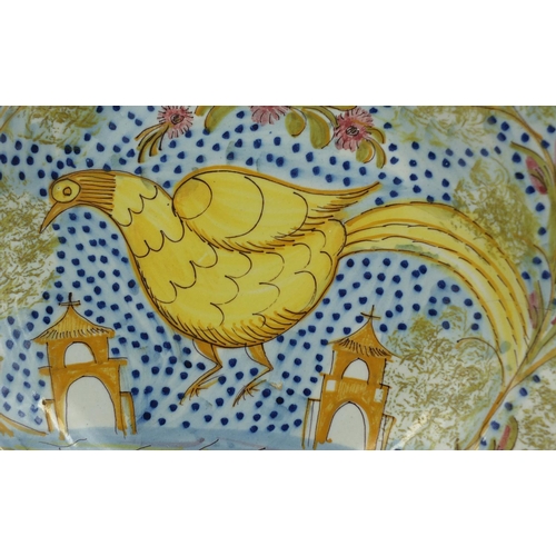 567 - Continental majolica shallow dish hand painted with a stylised bird in a landscape with churches, 30... 