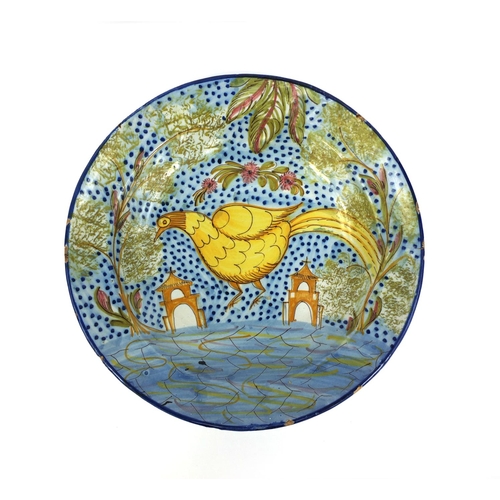 567 - Continental majolica shallow dish hand painted with a stylised bird in a landscape with churches, 30... 