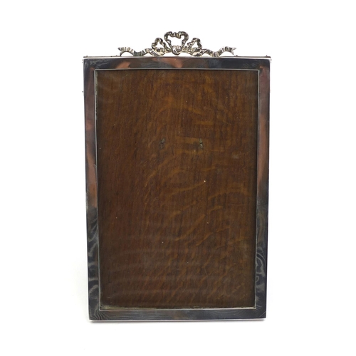 660 - Large rectangular silver easel photo frame with bow crest, M & S Birmingham 1905, 27cm high