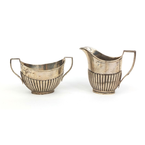 696 - Silver cream jug and twin handled sugar bowl, both with demi fluted decoration, London and Birmingha... 