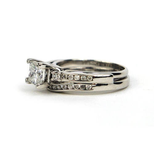 769 - White gold diamond ring set with a princess cut diamond and twenty seven smaller diamonds, size N, a... 