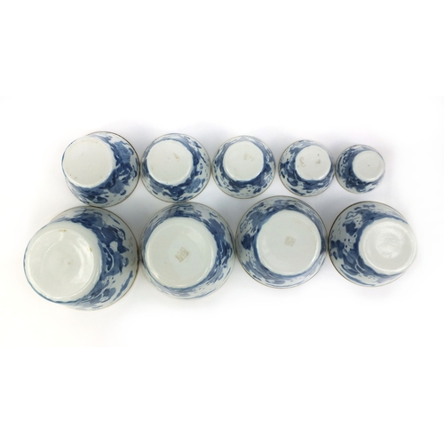 386 - Graduated set of nine Chinese blue and white porcelain bowls, each hand painted with a continuous ba... 