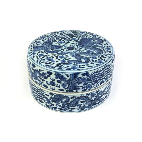 401 - Chinese circular blue and white porcelain box and cover, profusely hand painted with dragons and pho... 