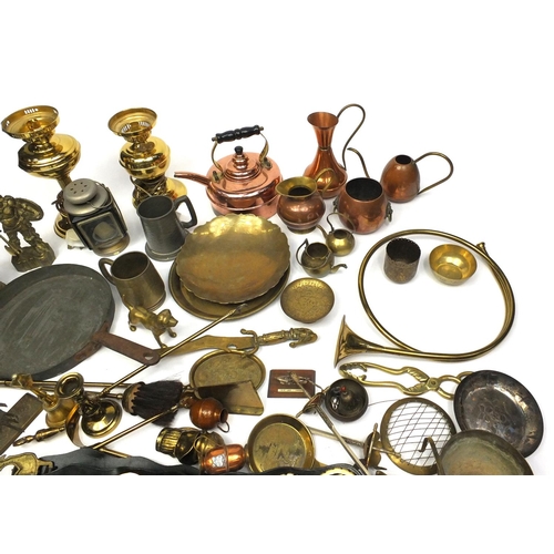 130 - Large selection of brass and copper items including horse brasses, hunting horn, jugs, lanterns, fir... 