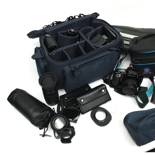 105 - Canon camera with spare lenses and a large selection of filters, two tripods etc