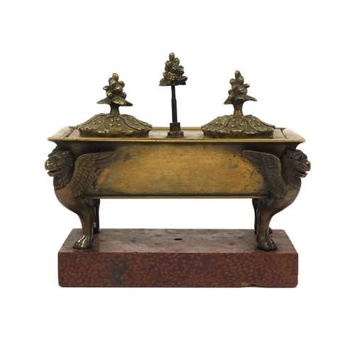 10 - Continental bronze twin inkwell with giffin supports, raised on a red marble base, 15cm high x 17cm ... 
