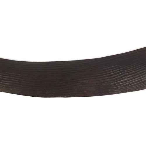 506 - Australian aboriginal interest wooden boomerang with carved decoration, 53cm long