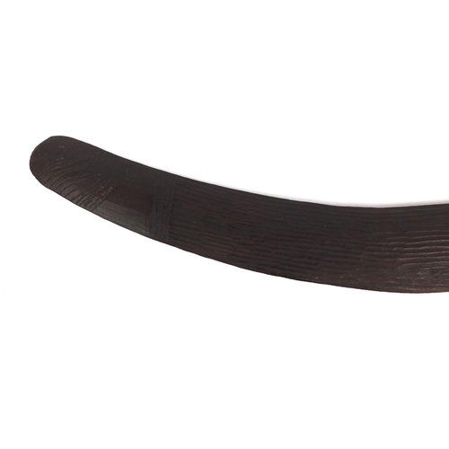 506 - Australian aboriginal interest wooden boomerang with carved decoration, 53cm long