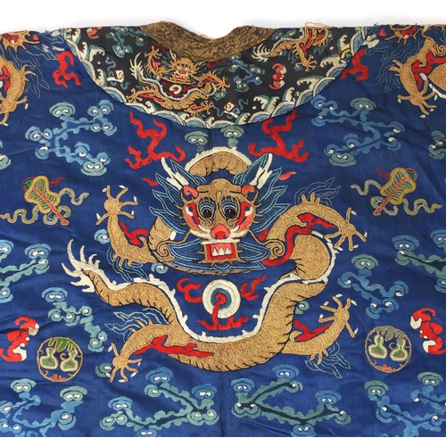 481 - Chinese silk blue ground dragon robe, profusely embroidered with dragons amongst clouds and bats, ab... 