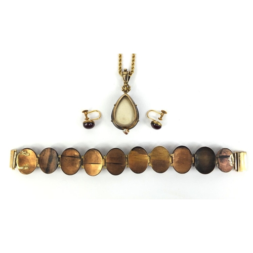 768 - Gilt metal cabochon garnet bracelet, pendant and earrings, the pendant set with seed pearls on a gil... 