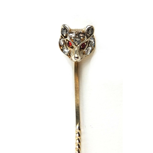 807 - Unmarked gold fox head tie pin set with nine diamonds and ruby eyes, 6.5cm long, approximate weight ... 