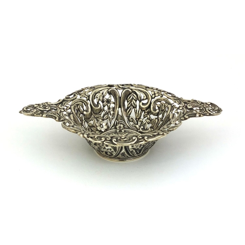 683 - Silver twin handled bon bon dish profusely embossed with flowers and vines and pierced decoration, H... 