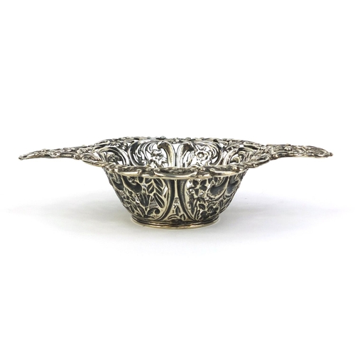 683 - Silver twin handled bon bon dish profusely embossed with flowers and vines and pierced decoration, H... 